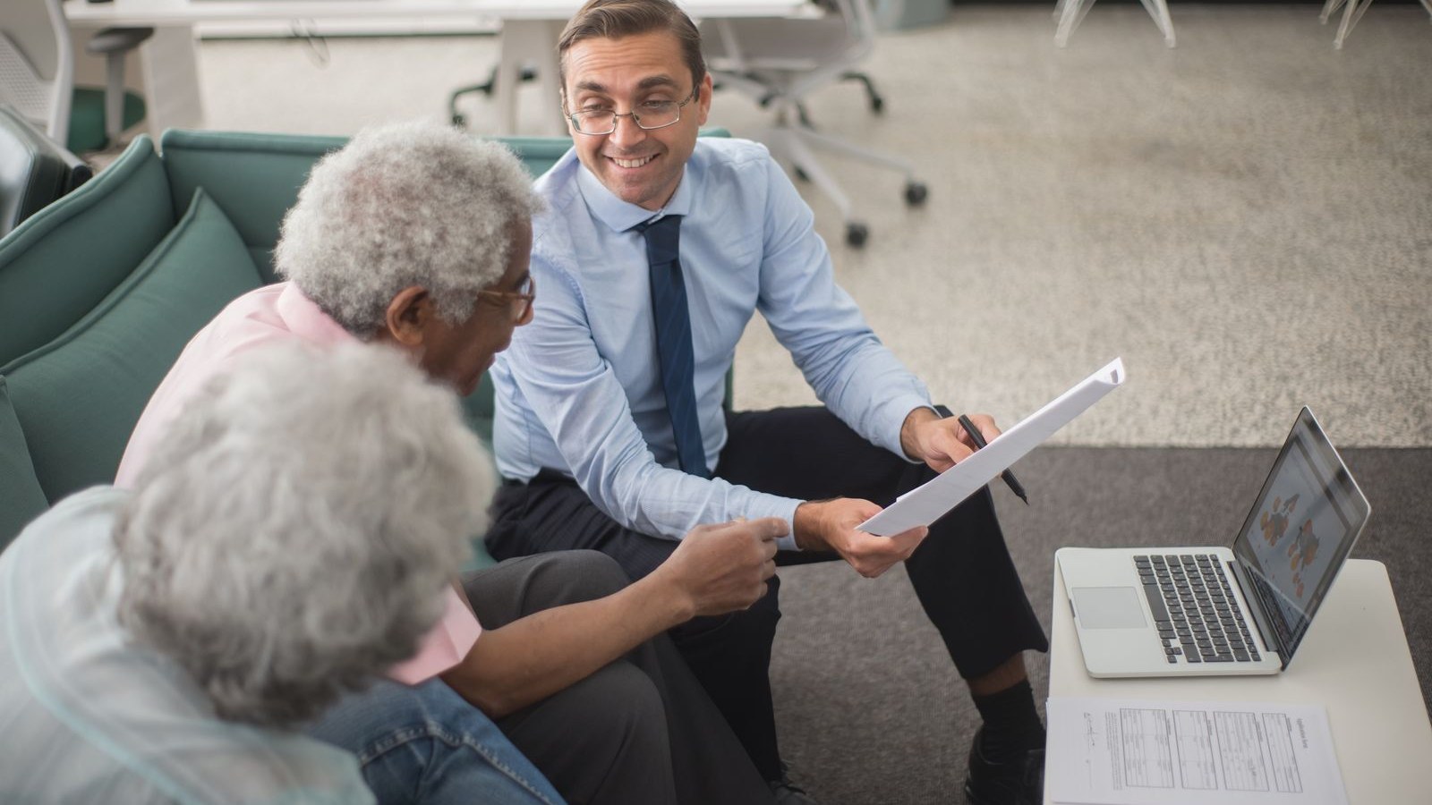 Advisor and client reviewing an insurance policy document at a desk — Digital Client Acquisition in the Insurance Sector