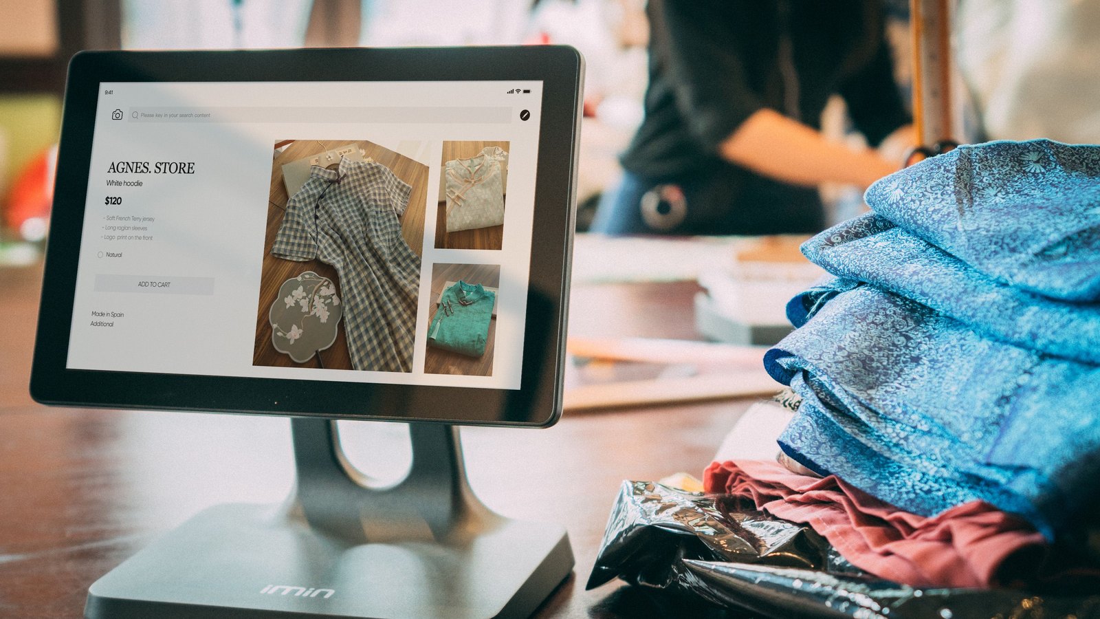 Merchant using a tablet point-of-sale device at a shop counter — Advisory Mandate: IoTourist Merchant Network Growth & Advertising