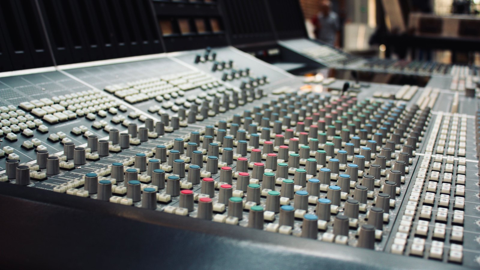 Musician recording in a professional music studio with mixing equipment — Building a Music Catalogue Revenue Ecosystem