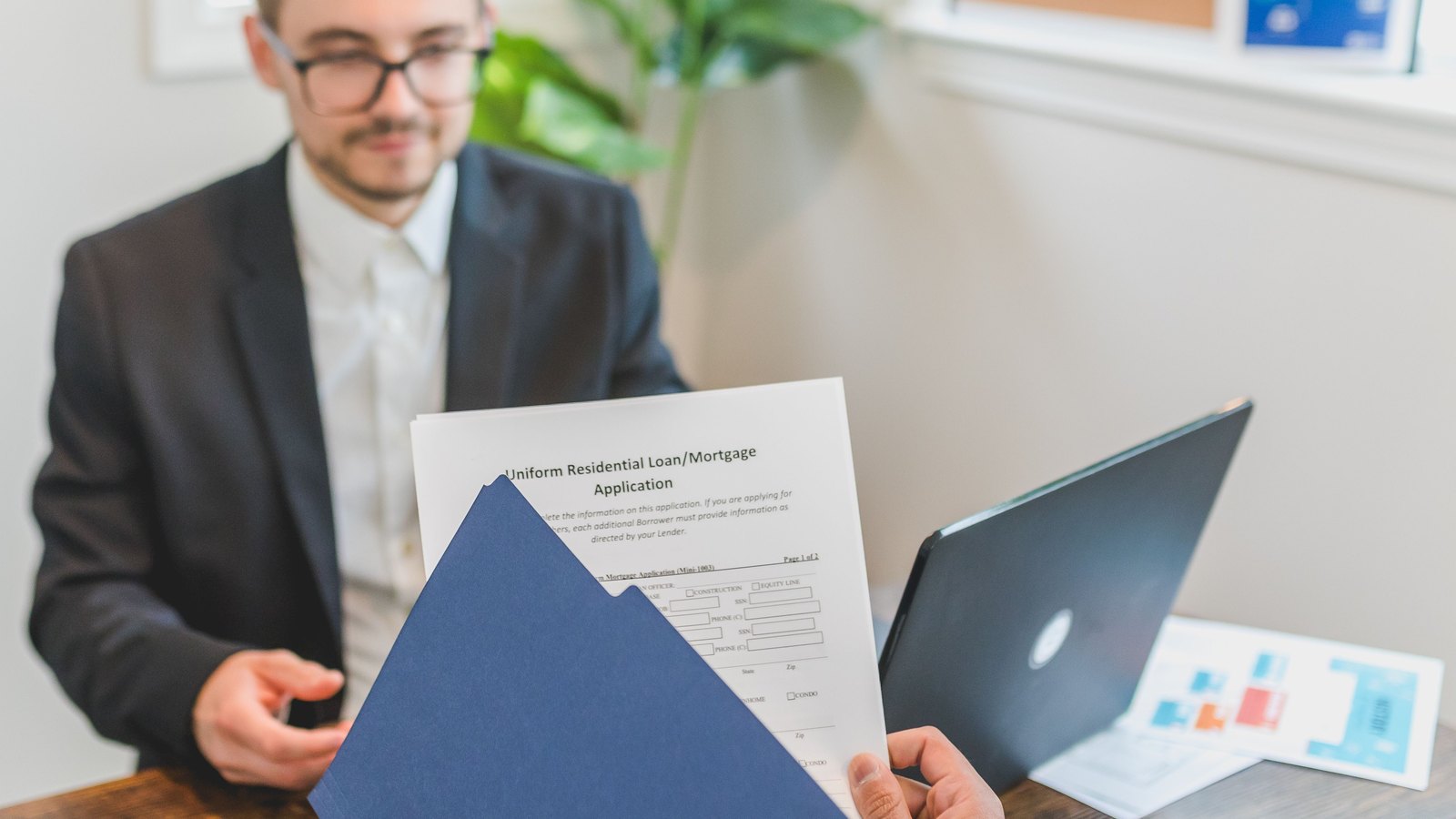 Investment advisor presenting financial figures to a client — Investment Advisory & Qualified Client Acquisition